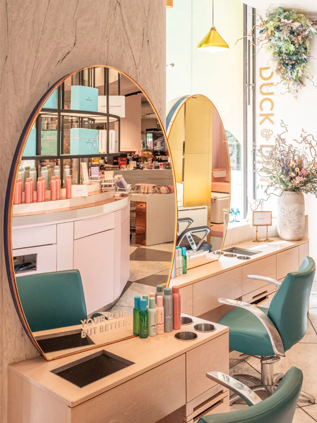 A beauty salon with a dressing table and mirror with a green chair