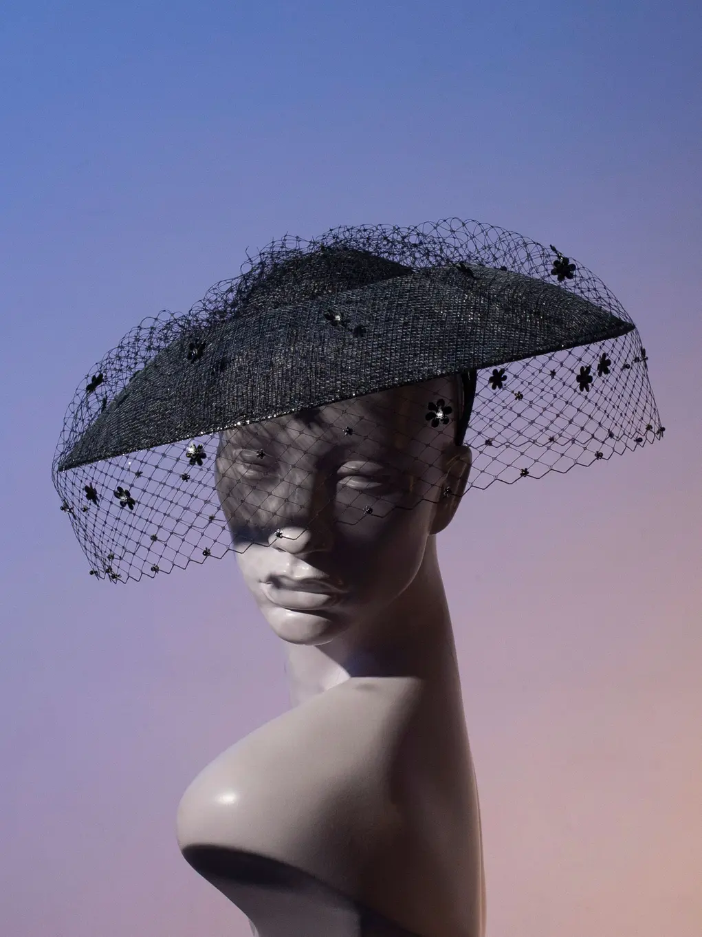 A mannequin wearing a black lacy hat