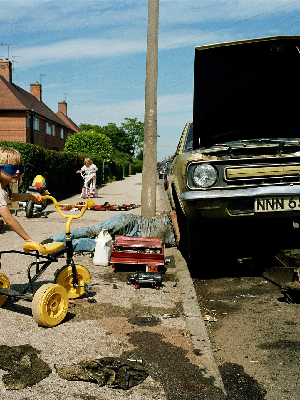 children playing and car being fixed