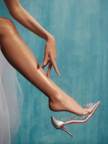 A woman's bare leg wearing a high heeled shoe