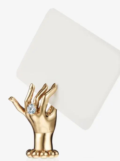 A gold hand place card holder