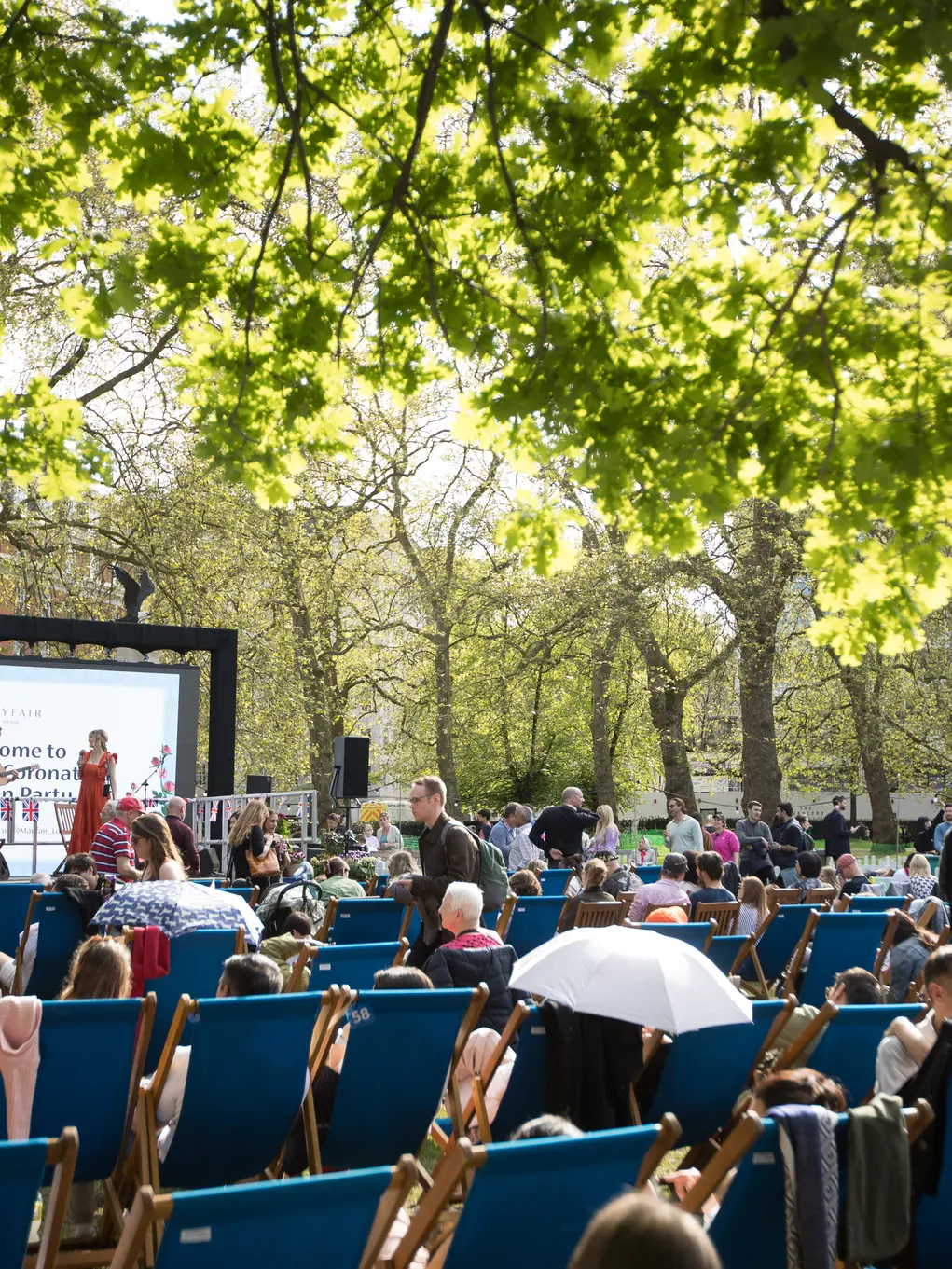 People on deckchairs facing a big screen in Grosvenor Square