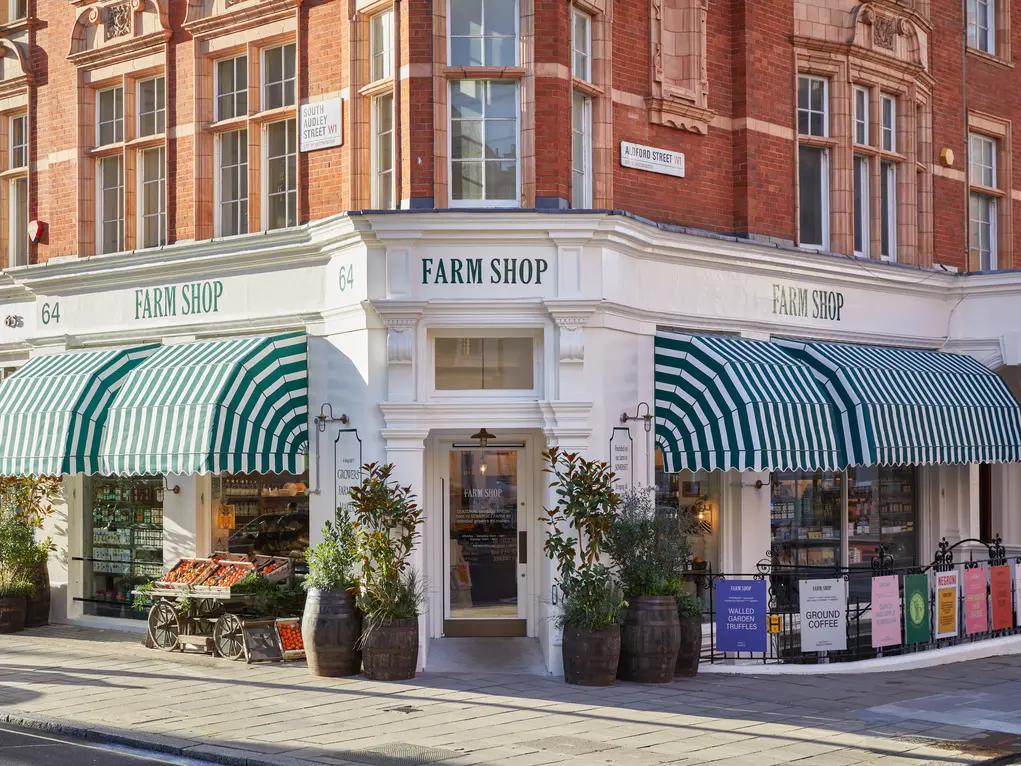 The exterior of Farm Shop with its green and white awning
